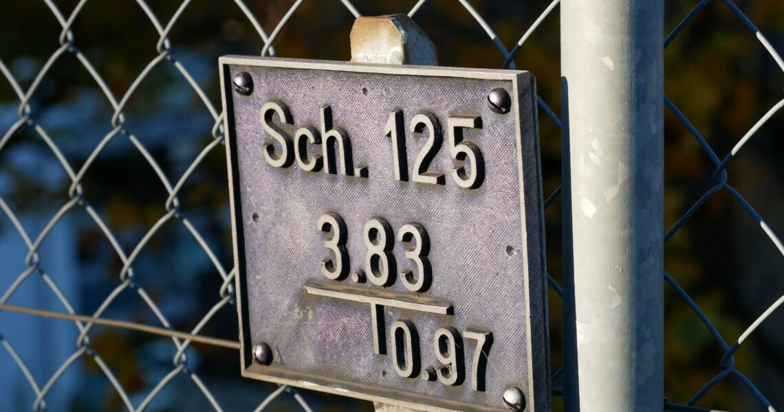 a close up of a sign on a fence